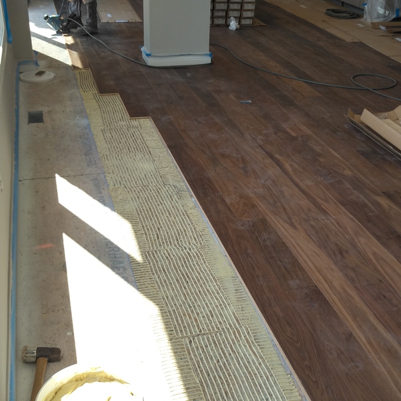 Glue assist installation of wide plank prefinished Hickory.